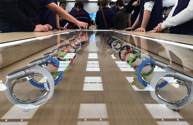 Apple Watches in a display case at an Apple store