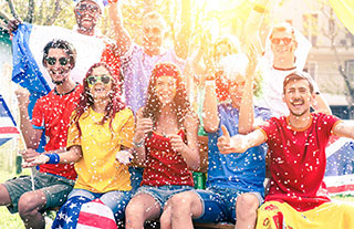 A group of aults throwing confetti and cheering on their teams.
